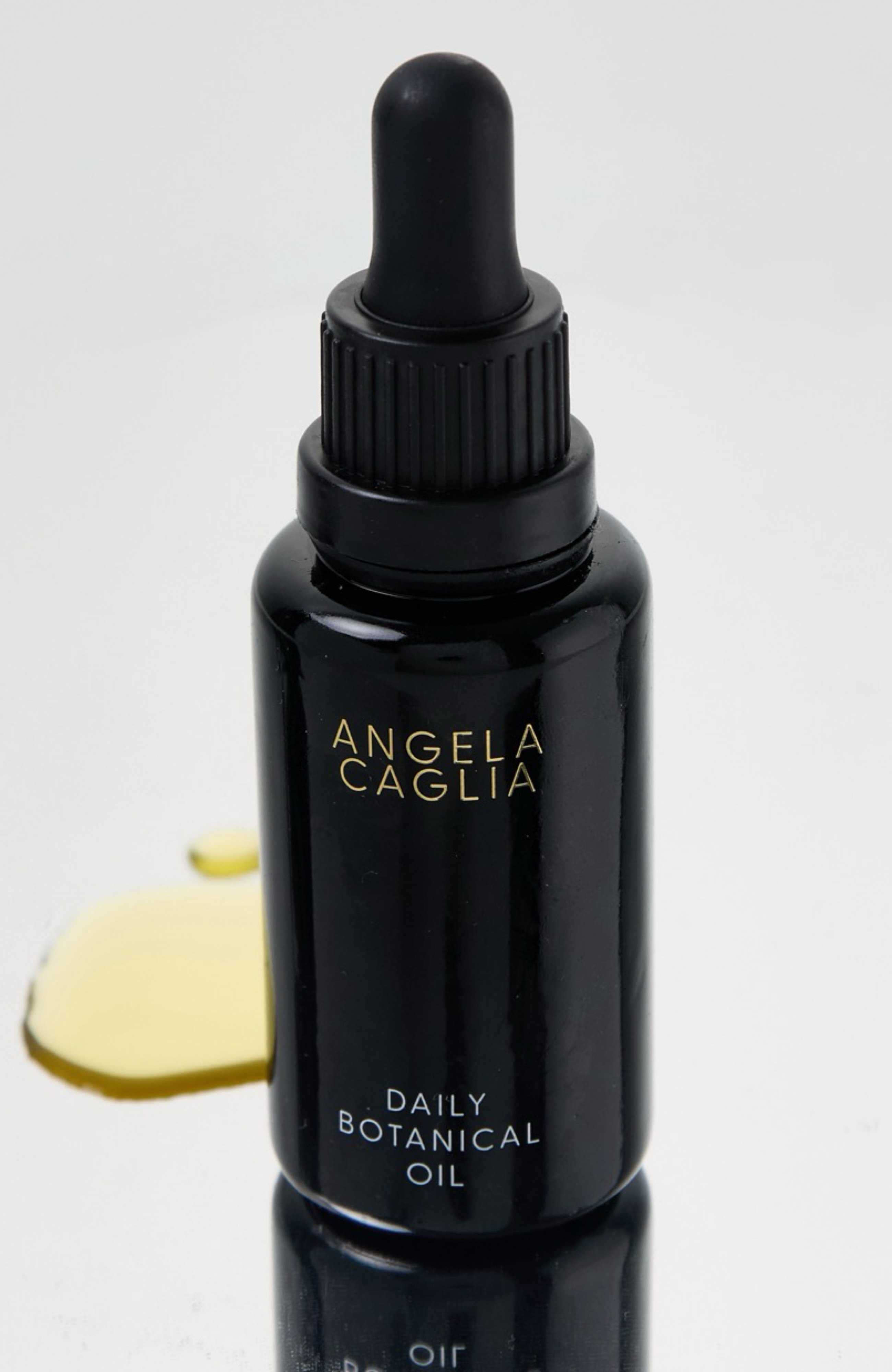 black botanical oil with product spill yellow